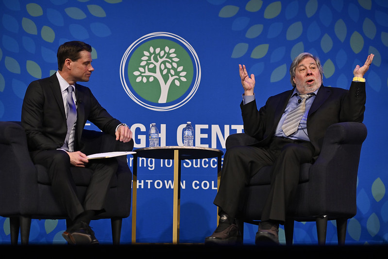 Two people seated on a stage hosting an event for The High Center at Elizabethtown College